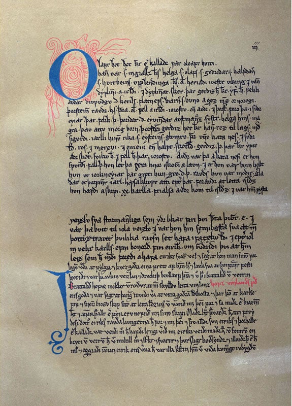 Illuminated manuscript page from Eirik the Red's Saga, featuring ornate red and blue initials and medieval Icelandic script written in black ink on aged parchment.