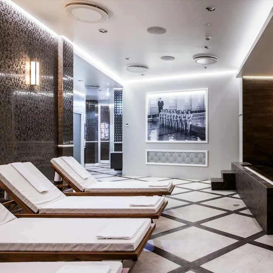 A luxurious relaxation area at Borg Spa by Kea Hotels features lounge chairs and elegant decor.