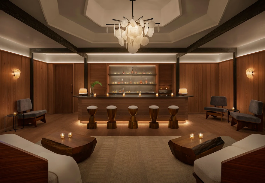 The luxurious relaxation lounge at The Spa at The Reykjavik EDITION, featuring a bar and warm lighting.
