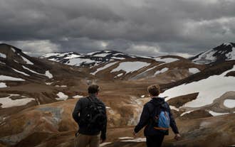 Hikers on Kerlingarfjoll hiking trails in Iceland’s Highlands with steaming valleys and snow patches.