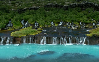 Streams of Hraunfossar pouring through lava rock into Hvita River on the Silver Circle route.