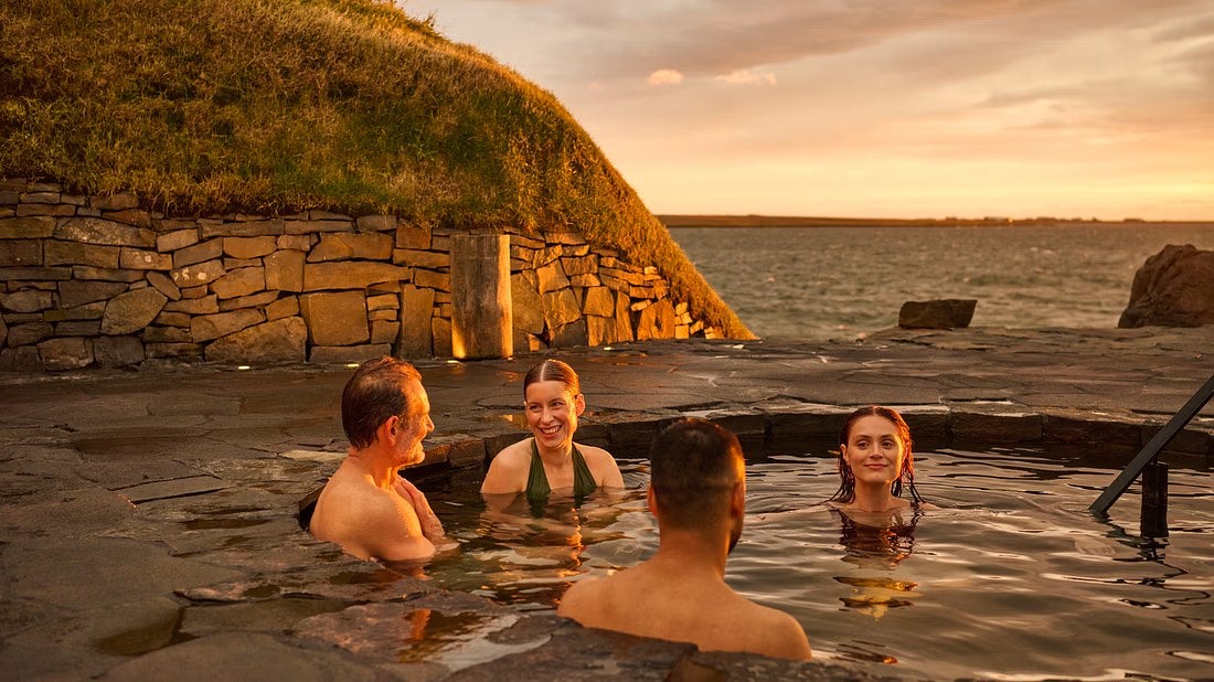 A group enjoys soaking in a geothermal pool at the Sky Lagoon near Reykjavik.