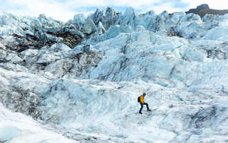 Jagged glacier ice forms sharp peaks and deep crevasses, shaped by years of movement and melting.