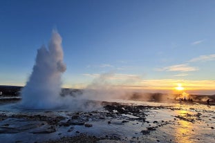 A geyser erupts at the Geysir geothermal area, one of the stops on this Golden Circle tour.