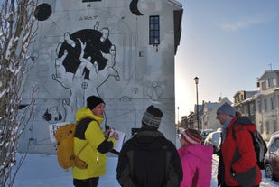 A local tour guide shows a group of tourists some street art in Reykjavik.