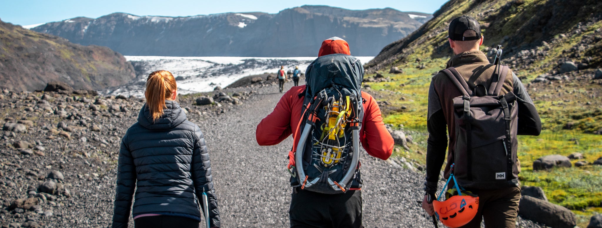 Hikers walk along the trail the Solheimajokull glacier in South Iceland.
