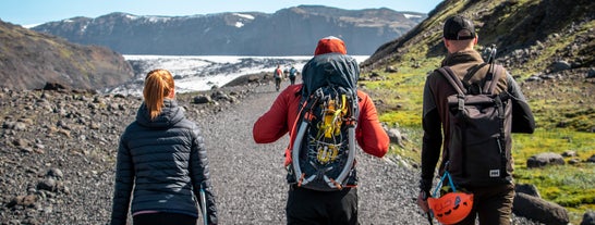 Hikers walk along the trail the Solheimajokull glacier in South Iceland.