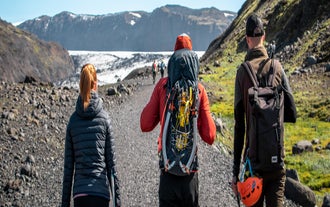 Hikers walk along the trail the Solheimajokull glacier in South Iceland.