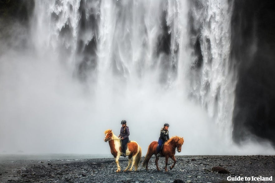 Horse riding by Sk&oacute;gafoss waterfall