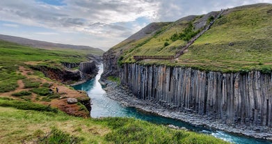 The Studalagil canyon is one of the most stunning destinations in East Iceland, with its towering basalt columns and water flowing below.