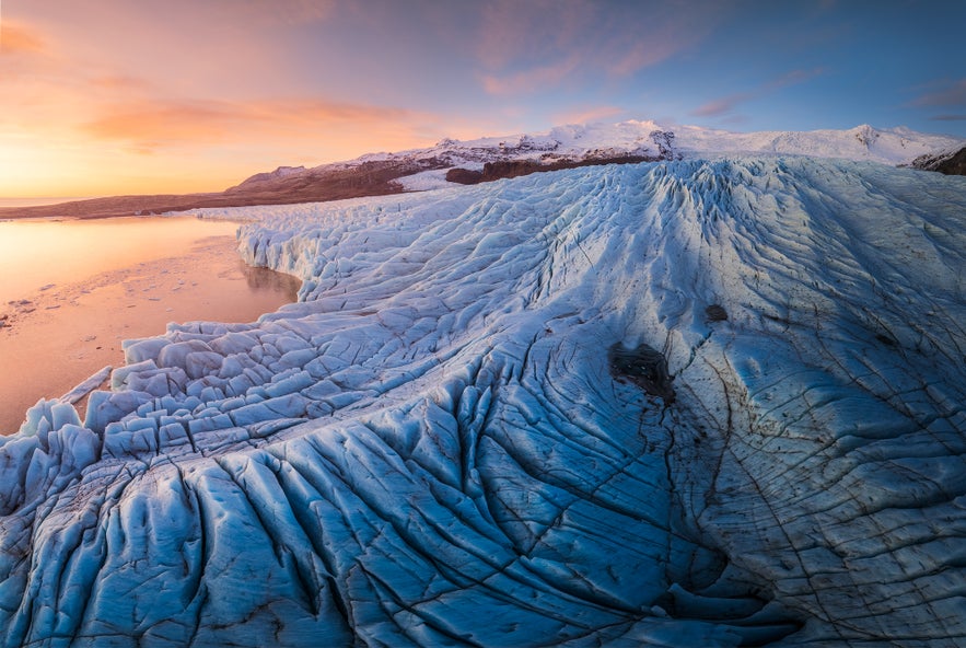 A glacier tongue in Skaftafell Nature Reserve shows deep crevasses and layered ice.