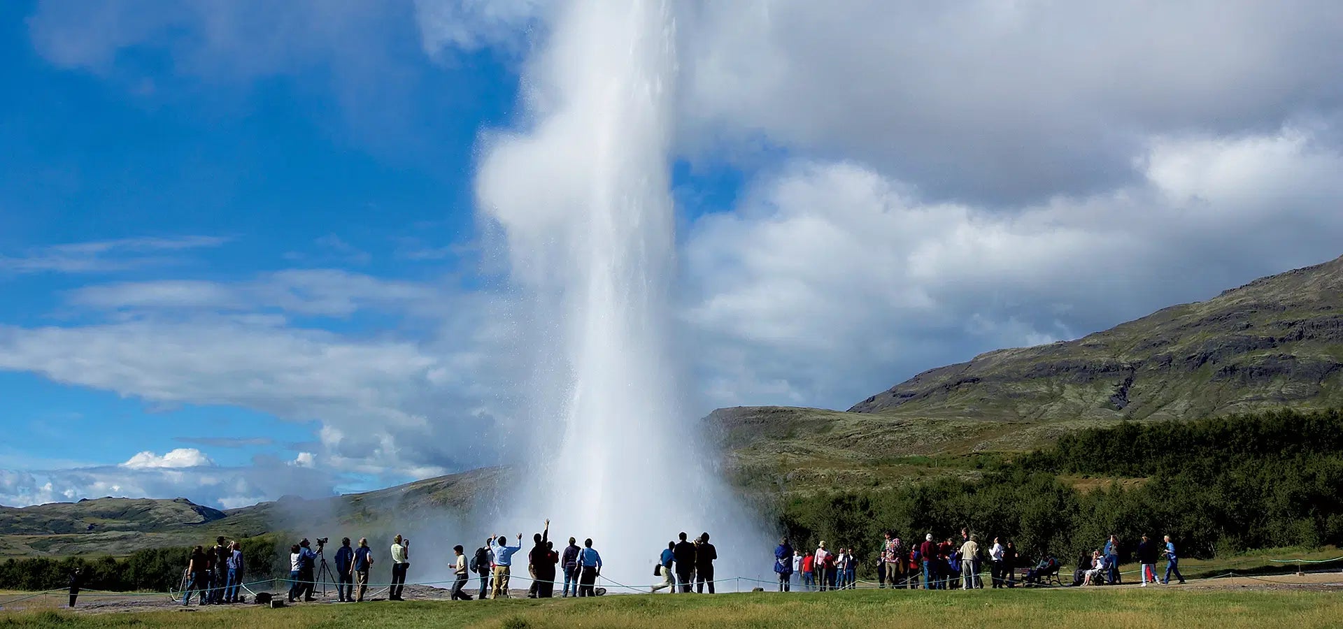 Steam rising from geothermal vents at Geysir on a Golden Circle tour in Iceland.