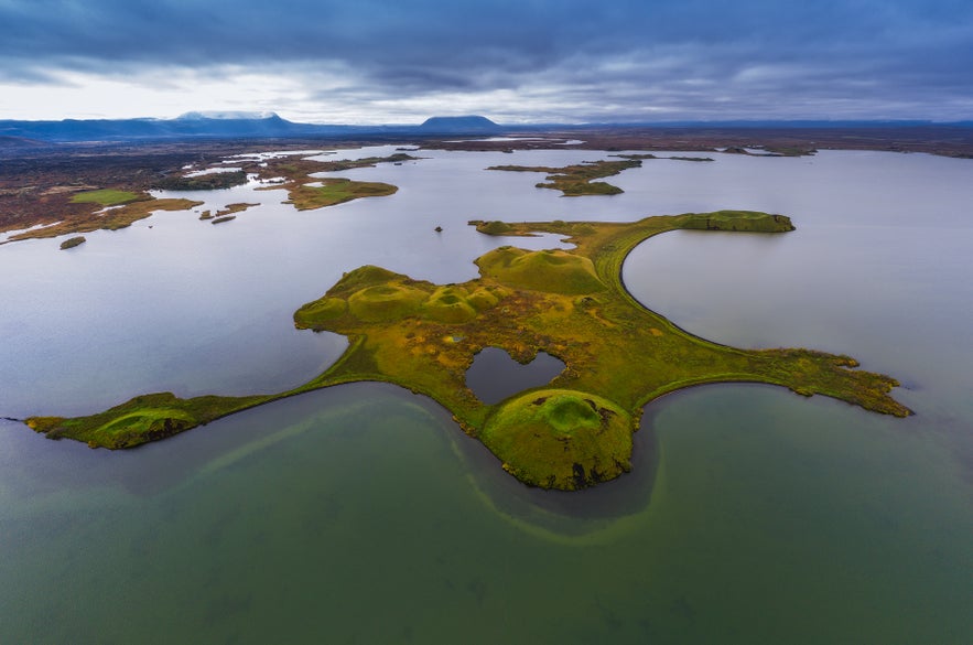 Aerial view of Lake Myvatn, Iceland, known for its volcanic islets and popular fishing spots in scenic surroundings.