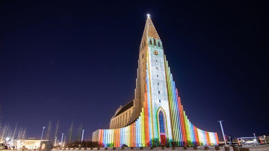 Reykjavik’s Hallgrimskirkja shines in rainbow hues for Winter Lights Festival, a bright moment in festivals in Iceland.