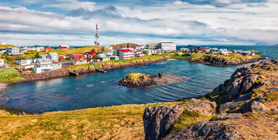 Scenic view of the small fishing town Stykkishólmur, Iceland, with colorful houses along the rocky coastline.