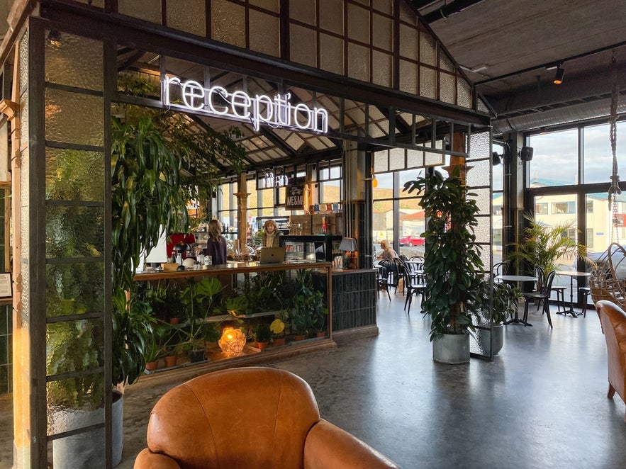Reception at The Greenhouse Hotel in Hveragerdi with a shopping area on its first floor.