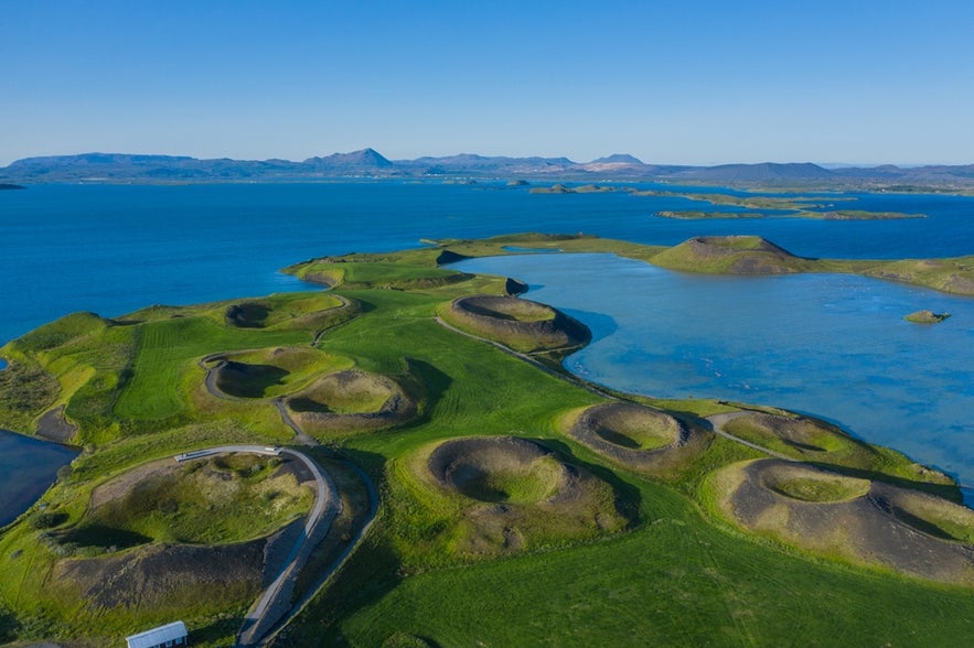 Aerial view of Lake Myvatn in North Iceland with green pseudocraters and volcanic terrain near Dettifoss Waterfall.