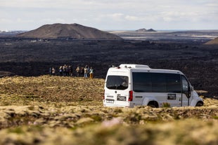 Volcano shuttle parked near tour group at Sundhnukagigar lava field viewpoint