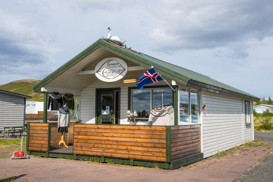 Dyngjan handcraft market by Lake Myvatn in Iceland, selling traditional wool sweaters and local handmade goods.