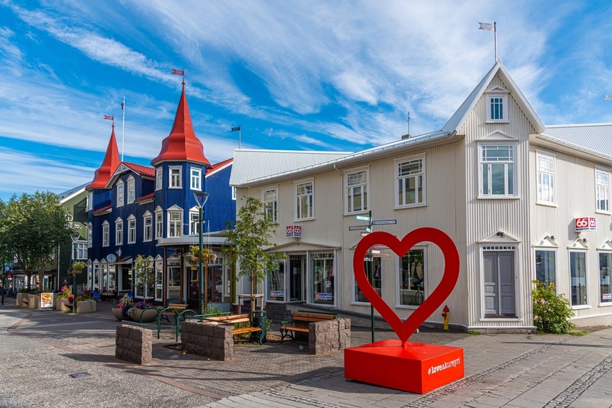 Colorful buildings and heart sculpture in Akureyri, the commercial center of North Iceland, on a sunny day.