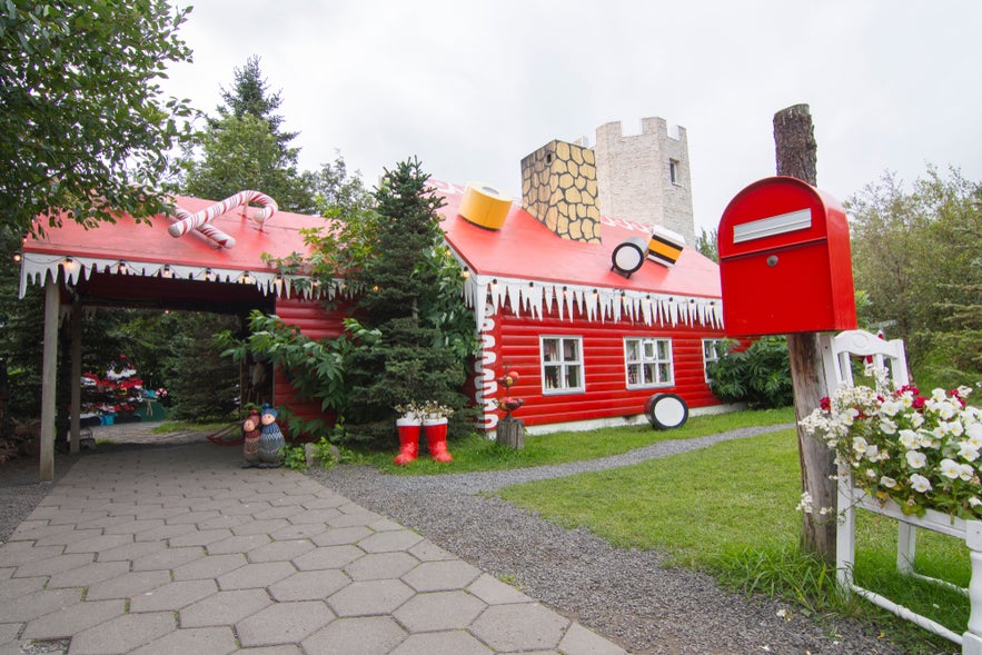 The Christmas House in Akureyri, North Iceland, with red walls, candy-themed roof, and festive decorations.