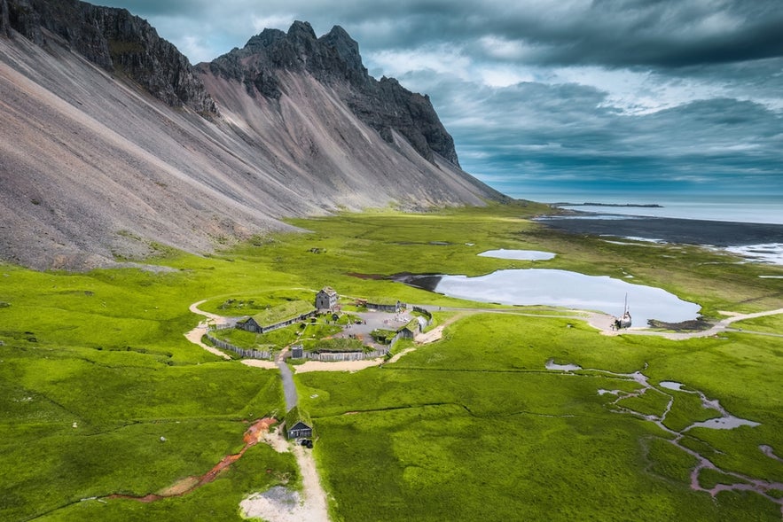 Aerial view of Viking Village Film Set at the base of Vestrahorn Mountain in Iceland. Aerial view of Viking Village Film Set at the base of Vestrahorn Mountain in Iceland.