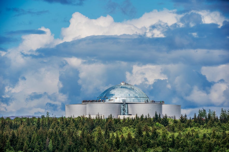 The Perlan is an iconic building on a big hill overlooking the city of Reykjavik