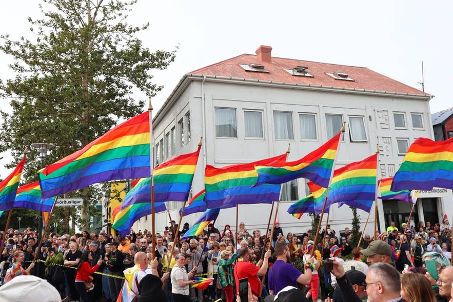 Rainbow flags carried through a Reykjavik street during the annual Pride Parade.