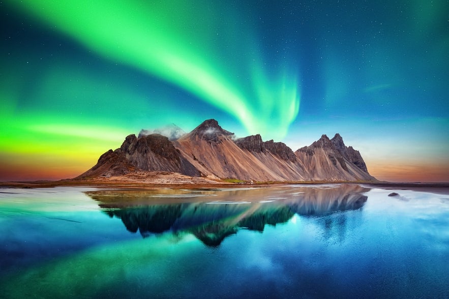 Northern lights over Vestrahorn Mountain, a view not possible in Iceland in June due to continuous daylight.