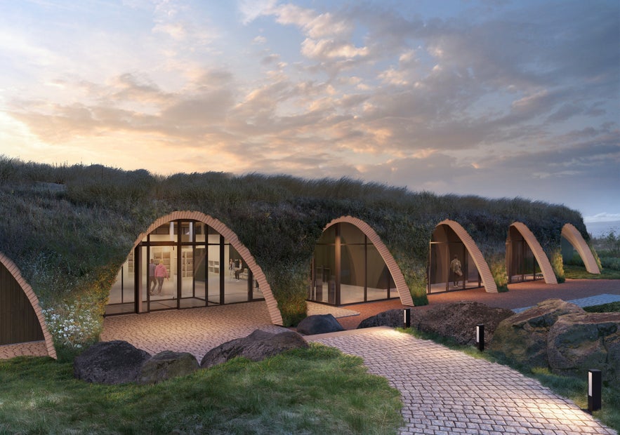 Exterior of Laugaras Lagoon’s entrance showing modern turf-roof design at sunset in South Iceland.