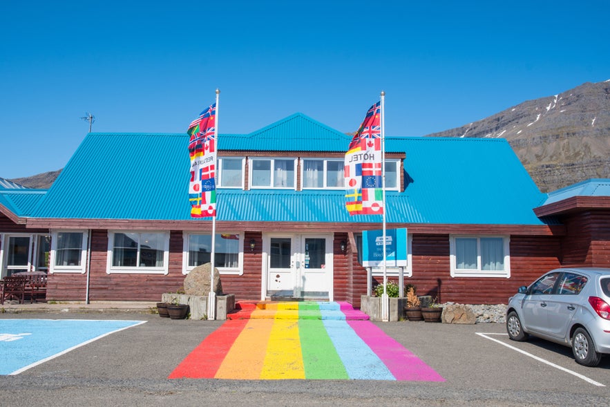 Rainbow flag painted on the ground in front of Hotel Bláfell in Breiddalsvik, East Iceland