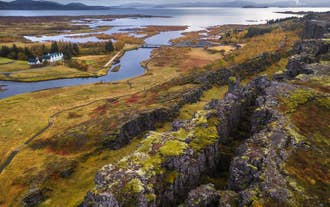 Drohnenaufnahme über dem Thingvellir-Grabenbruch und dem See Thingvallavatn, die Islands geologische Wunder am Goldenen Kreis zeigen.