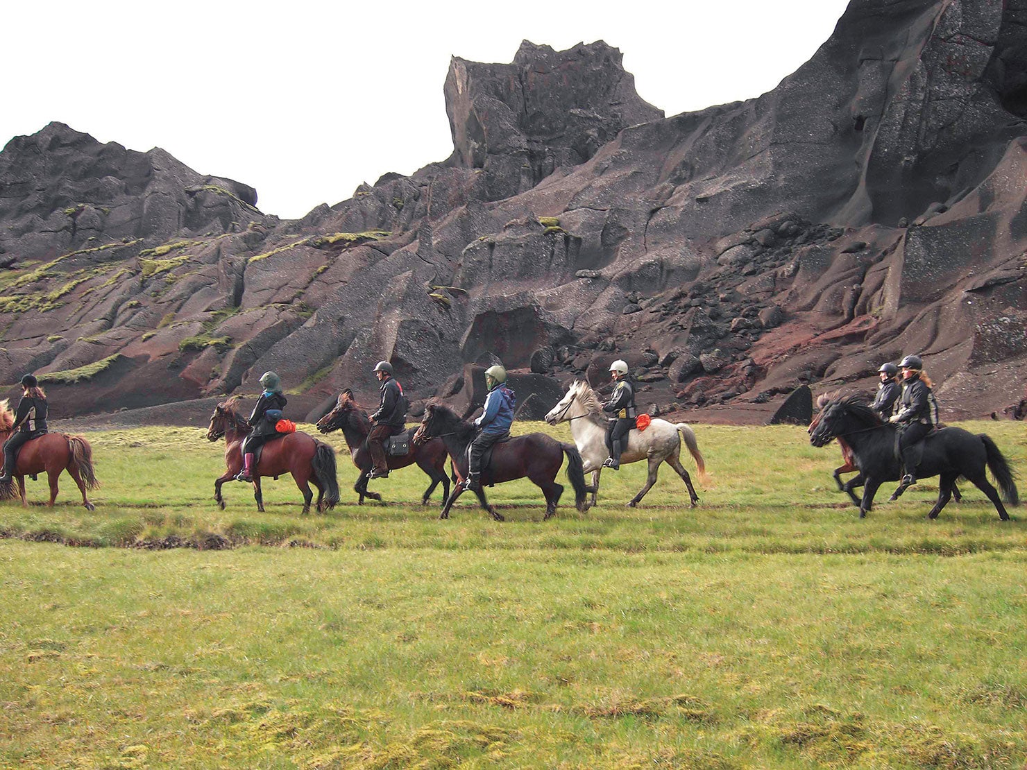 Experienced riders traverse the lush green terrain of the Valley of Horses – Marardalur in the Hengill volcano area.