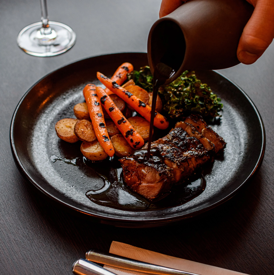Grilled lamb with roasted vegetables and sauce at Kjarr Restaurant and Bar in South Iceland. 