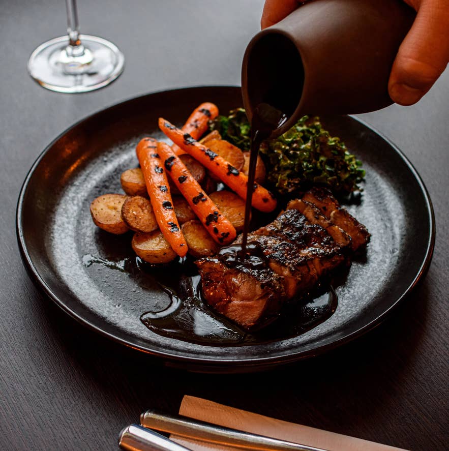 Grilled lamb with roasted vegetables and sauce at Kjarr Restaurant and Bar in South Iceland.