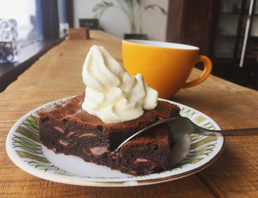 Chocolate brownie with whipped cream and coffee at Cafe Vatnajokull in South Iceland. 