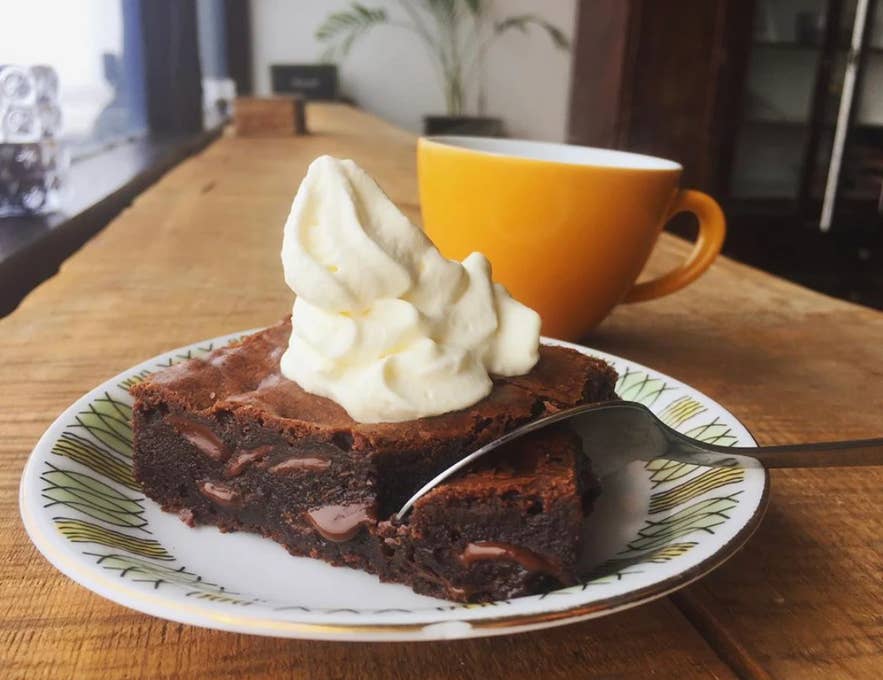 Chocolate brownie with whipped cream and coffee at Cafe Vatnajokull in South Iceland. 