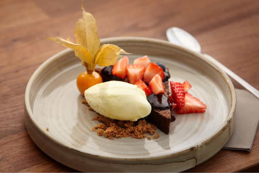 Chocolate cake with vanilla ice cream and fresh strawberries at Klaustur Restaurant and Bar, a South Iceland restaurant.
