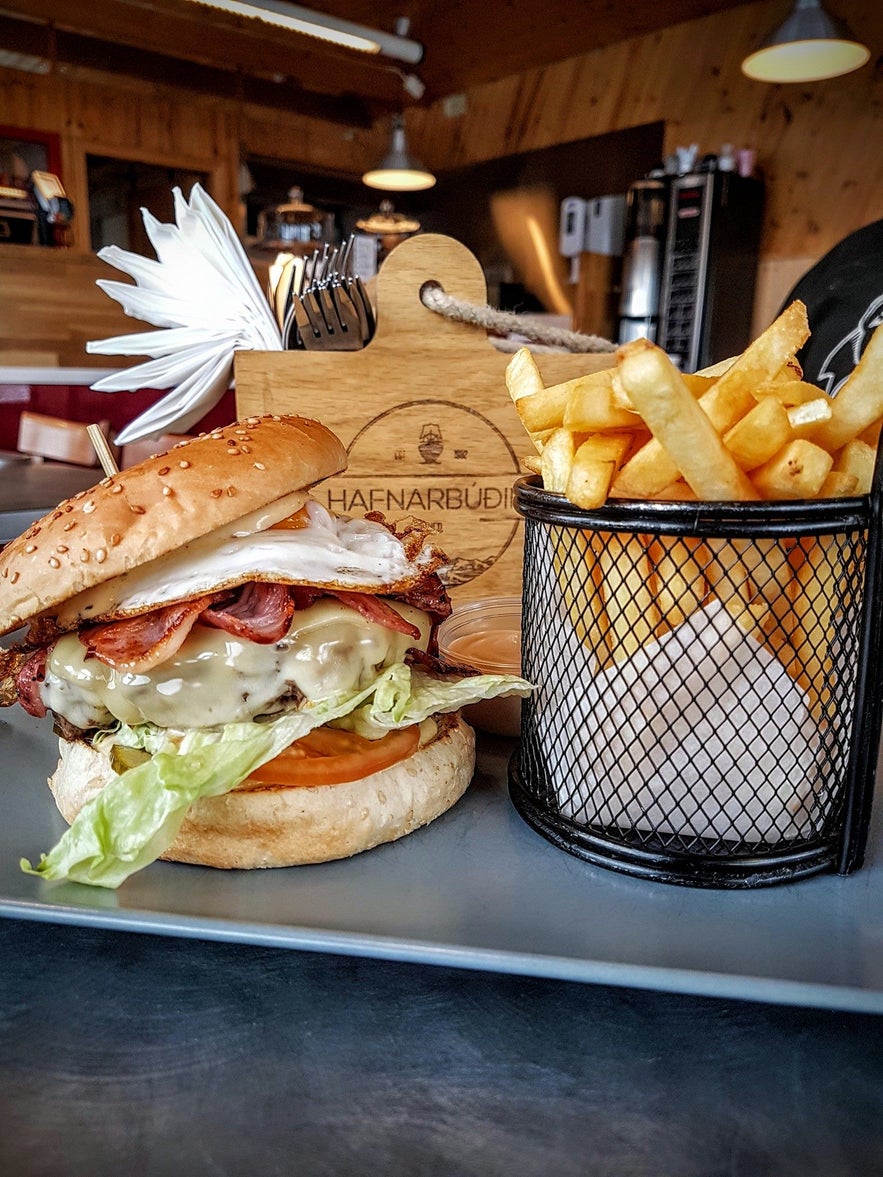 Cheeseburger with bacon, fried egg, and fries served at Hafnarbudin, in South Iceland. 