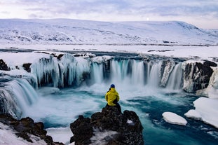 Captivating Frozen Beauty: Godafoss Waterfall in its Winter Splendor.