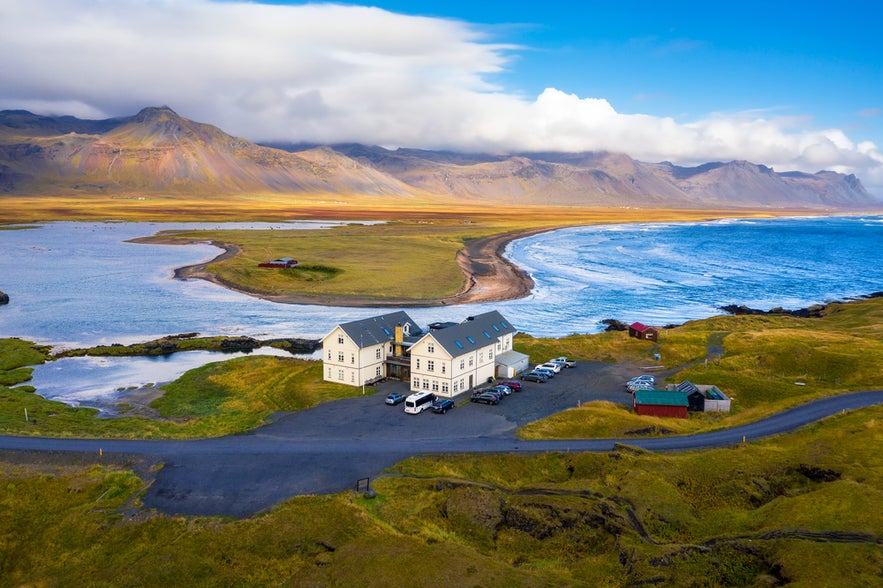 Budir Beach, Iceland, with mountains, ocean waves, and a dramatic coastal landscape.