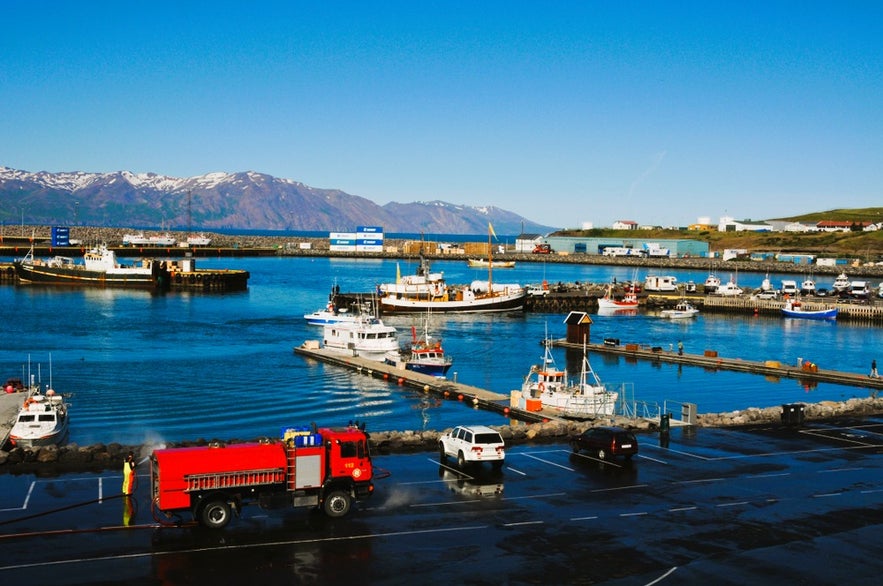 Akureyri Harbor with boats and fjord views, a major cruise stop for travelers exploring Iceland by cruise ship.