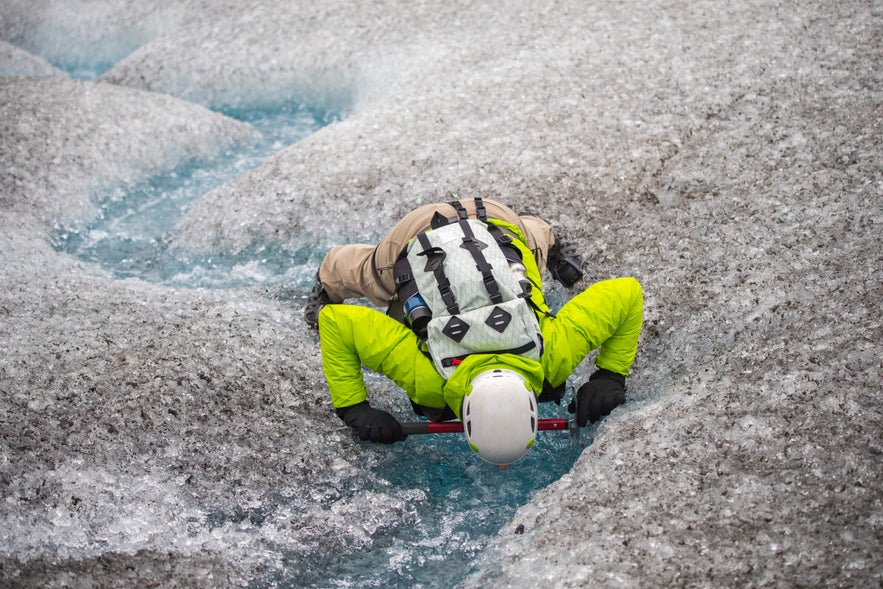 Drinking fresh glacial water during an ice hike in Iceland, a refreshing adventure and one of the best Iceland travel tips.