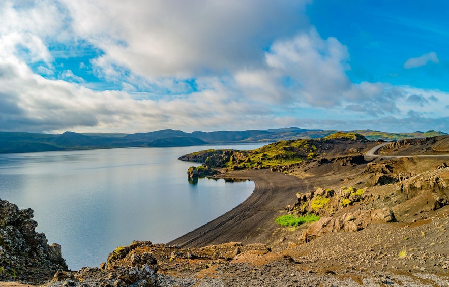 Scenic view of Kleifarvatn Lake on the Reykjanes Peninsula in Iceland with volcanic landscape and calm summer skies