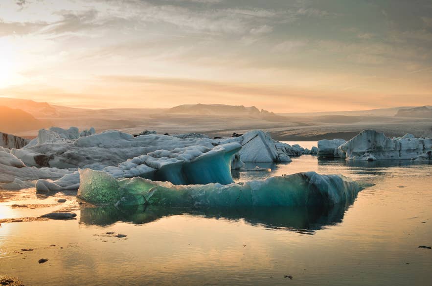 夕暮れのヨークルスアゥルロゥン氷河湖。流氷が浮かび、静かな水面に映る絶景。