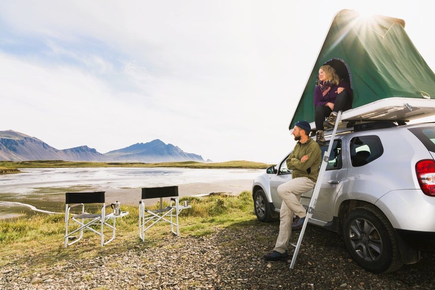 Rooftop tent camping on a road trip while driving in Iceland in August near Snaefellsnes Mountains and Stykkisholmur Coast.