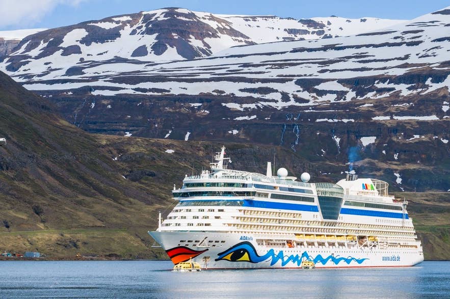AIDA ship anchored offshore near Seydisfjordur, a dramatic scene in East Iceland when exploring Iceland by cruise ship.