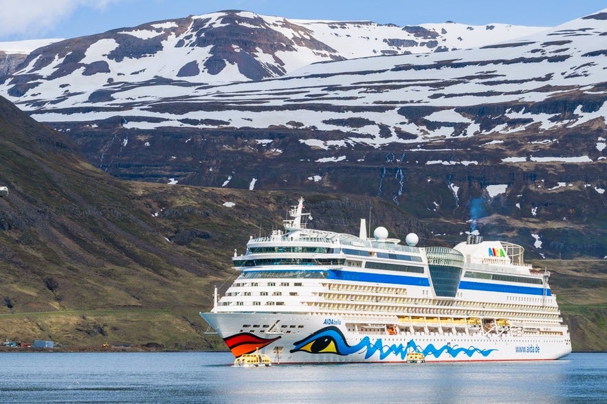 AIDA ship anchored offshore near Seydisfjordur, a dramatic scene in East Iceland when exploring Iceland by cruise ship.