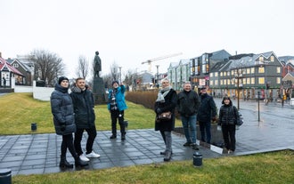 A group of travelers enjoying a private walking tour in Reykjavik led by a local guide.