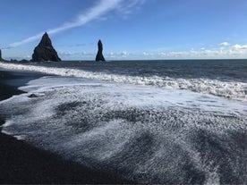 Experience the captivating beauty of Reynisfjara Beach, where stunning black sands meet the powerful Atlantic waves.